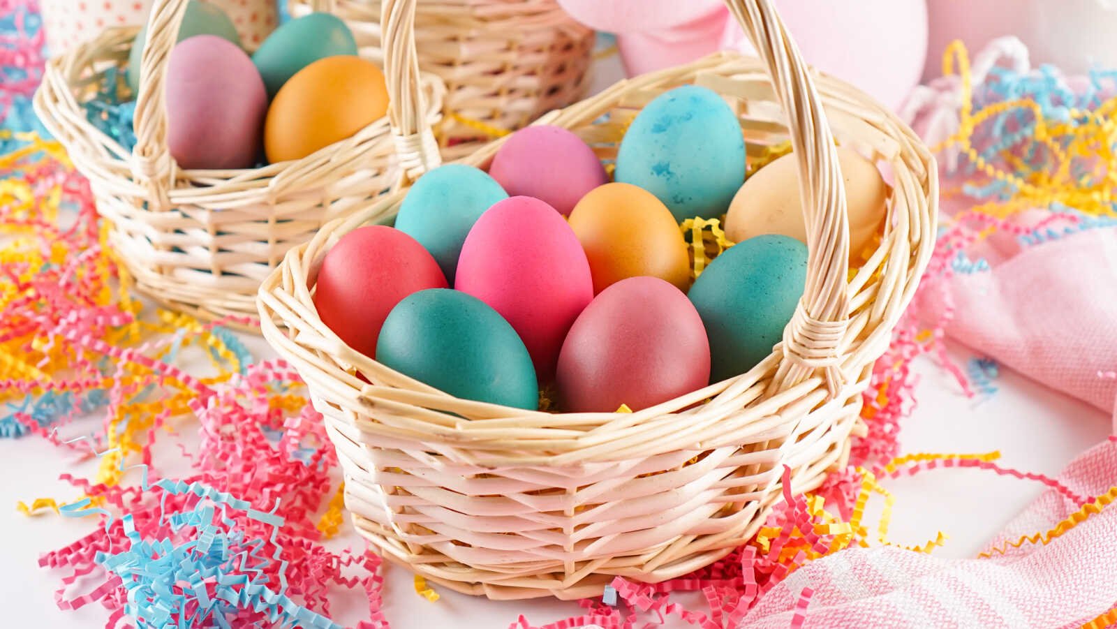 Wicker baskets filled with pastel eggs made when you dye brown eggs.